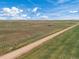 Aerial view of a long dirt road through farmland at 15 S County Road 197, Byers, CO 80103