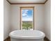 Bathroom featuring a relaxing soaking tub and a view at 15 S County Road 197, Byers, CO 80103
