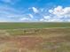 Aerial view of a house and outbuilding on farmland at 15 S County Road 197, Byers, CO 80103