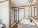 Bathroom with shower, double vanity, and wood flooring at 15 S County Road 197, Byers, CO 80103