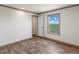 Bright bedroom with wood-look floors and a view at 15 S County Road 197, Byers, CO 80103