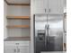 White shaker cabinets and floating shelves in kitchen at 15 S County Road 197, Byers, CO 80103