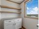 Floating shelves and white cabinets in kitchen area at 15 S County Road 197, Byers, CO 80103