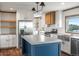 Modern kitchen with stainless steel appliances, blue island, and ample counter space at 15 S County Road 197, Byers, CO 80103