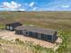 Aerial view of home, garage and surrounding land at 15 S County Road 197, Byers, CO 80103