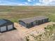 Aerial view of a house and detached garage on acreage at 15 S County Road 197, Byers, CO 80103