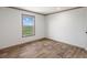 Spacious bedroom featuring wood-look floors and large window at 15 S County Road 197, Byers, CO 80103
