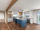 Open concept kitchen featuring a large island and wood beams at 15 S County Road 197, Byers, CO 80103