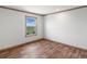 Simple bedroom with window and hardwood floors at 15 S County Road 197, Byers, CO 80103