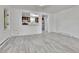 Open living room and kitchen with grey vinyl plank flooring at 4550 Miller St, Wheat Ridge, CO 80033