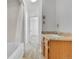 Simple bathroom with a shower/tub combo and wood vanity at 4550 Miller St, Wheat Ridge, CO 80033