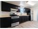 Kitchen with dark cabinets and stainless steel appliances at 4550 Miller St, Wheat Ridge, CO 80033