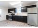 Kitchen with dark cabinets and stainless steel appliances at 4550 Miller St, Wheat Ridge, CO 80033