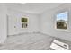 Bright bedroom with new flooring and neutral walls. Features a door and two large windows at 4550 Miller St, Wheat Ridge, CO 80033