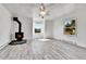 Living room featuring wood-burning stove and laminate flooring at 4550 Miller St, Wheat Ridge, CO 80033