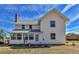 White farmhouse with a sunroom at 4550 Miller St, Wheat Ridge, CO 80033