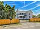 Front view of a white farmhouse with a fenced yard at 4550 Miller St, Wheat Ridge, CO 80033