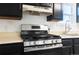 Stainless steel range in a kitchen with dark cabinets at 4550 Miller St, Wheat Ridge, CO 80033