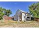 White outbuilding with weathered siding and various tools and equipment visible at 4550 Miller St, Wheat Ridge, CO 80033