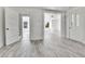 Bright hallway with access to other rooms and laminate flooring at 4550 Miller St, Wheat Ridge, CO 80033