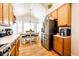 Kitchen with stainless steel refrigerator, oak cabinets, and a dining area at 5461 E 116Th Ave, Thornton, CO 80233