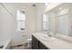 Clean bathroom with white tiled shower and dark vanity at 1578 Farmstead St, Brighton, CO 80601