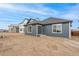 Rear view of a gray house with a small yard at 1578 Farmstead St, Brighton, CO 80601