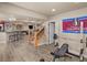 Finished basement with gym area, bar, and stairs leading to the main level at 10215 W Wesley Dr, Lakewood, CO 80227