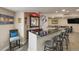 Finished basement bar with seating and granite countertop at 10215 W Wesley Dr, Lakewood, CO 80227