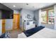 Main bedroom with large TV, dresser and window views at 10215 W Wesley Dr, Lakewood, CO 80227