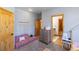 Bedroom with a sofa bed, dresser, and en-suite bathroom access at 10215 W Wesley Dr, Lakewood, CO 80227