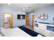 Main bedroom with large TV, dresser, and en-suite bathroom at 10215 W Wesley Dr, Lakewood, CO 80227