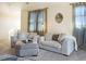 Comfortable sitting area with plush sofas and a cozy ottoman at 10215 W Wesley Dr, Lakewood, CO 80227