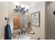 Elegant bathroom with modern vanity, decorative mirror, and lovely accents at 10215 W Wesley Dr, Lakewood, CO 80227