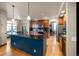 Open kitchen with large island, stainless steel appliances, and hardwood floors at 10215 W Wesley Dr, Lakewood, CO 80227