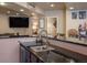 Partial view of a basement bar with sink and granite countertop at 10215 W Wesley Dr, Lakewood, CO 80227