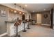Basement wet bar with stone feature wall and wine storage at 22435 Boundstone Dr, Parker, CO 80138