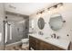 Bathroom with double vanity, large mirror, and walk-in shower at 22435 Boundstone Dr, Parker, CO 80138