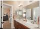 Double vanity bathroom with access to bedroom and hallway at 22435 Boundstone Dr, Parker, CO 80138