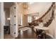 Bright entry with hardwood floors, elegant staircase, and views into the living areas at 22435 Boundstone Dr, Parker, CO 80138