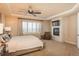 Main bedroom with fireplace, carpeted floors, and large window with plantation shutters at 22435 Boundstone Dr, Parker, CO 80138