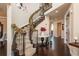 Open staircase with decorative railing and garland; view of entry and upper floor at 22435 Boundstone Dr, Parker, CO 80138