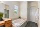 Relaxing bathroom with a large bathtub and tile flooring at 2342 Kelty Ct, Franktown, CO 80116