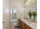 Bathroom with double vanity, large mirror, and access to a separate shower and tub at 2342 Kelty Ct, Franktown, CO 80116