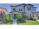 Two-story townhome with gray siding, landscaping, and a walkway at 3356 Ireland Moss St, Castle Rock, CO 80109