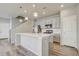 Modern kitchen with white cabinets and an island at 3356 Ireland Moss St, Castle Rock, CO 80109