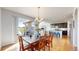 Bright dining room with wooden table and chairs, adjacent to the kitchen at 10722 E 162Nd Pl, Brighton, CO 80602