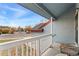 Small front porch with white railing and a wicker chair at 9451 Garden Ct, Highlands Ranch, CO 80126