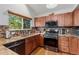 Modern kitchen with granite countertops, stainless steel appliances, and wood cabinets at 9451 Garden Ct, Highlands Ranch, CO 80126