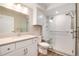 Updated bathroom with walk-in shower and white vanity at 3144 S Wheeling Way # 107, Aurora, CO 80014